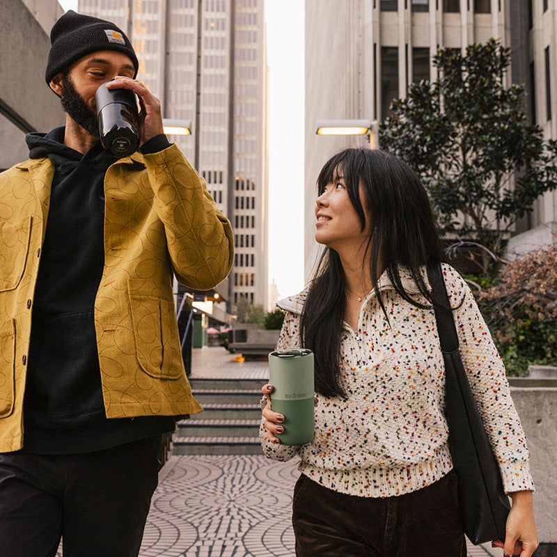 16oz-rise-tumbler-t8 16oz_rise_tumbler_black_iceberg_couple_drink_city_street_square.jpg