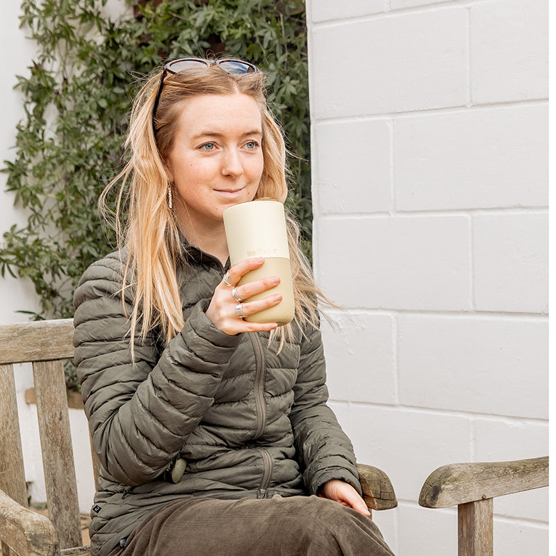 16oz-rise-tumbler-t8 16oz_rise_tumbler_wax_yellow_woman_seat_outside_square.jpg