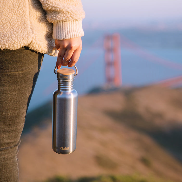 27oz-reflect-with-bamboo-cap-c4 K27SSLRF-BS-BAMBOO_reflect_bottle_bridge_lifestyle.jpg