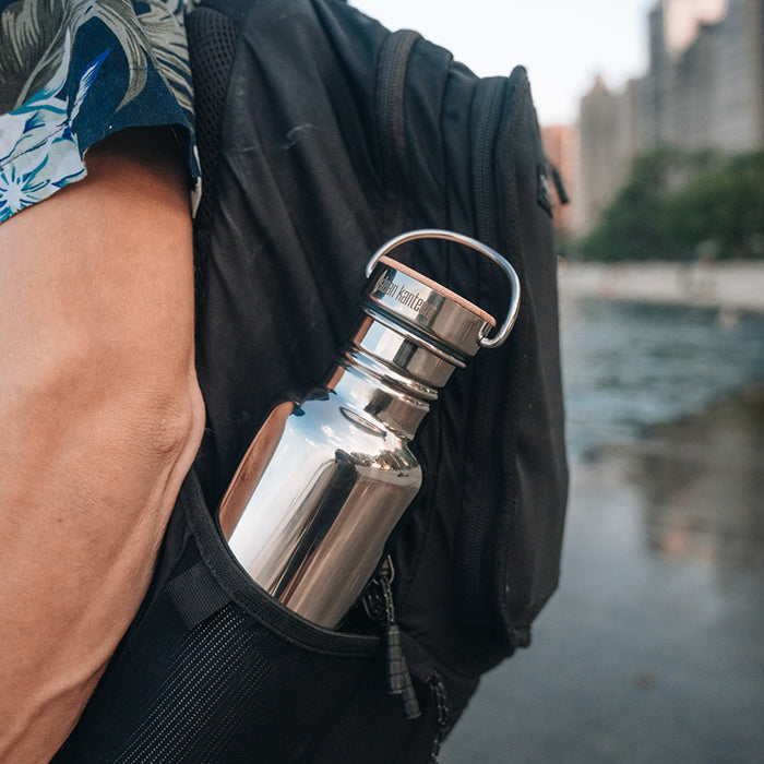 27oz-reflect-with-bamboo-cap-c4 K27SSLRF-MS-BAMBOO_reflect-bottle_backpack_lifestyle.jpg